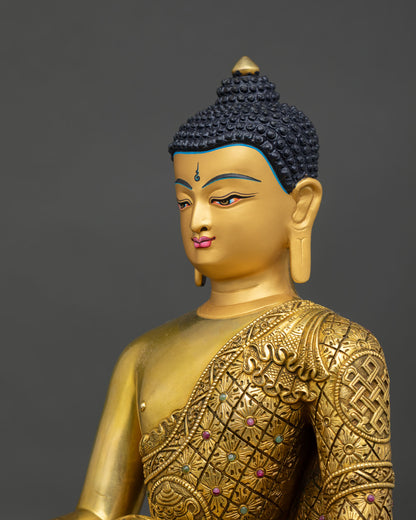 Side detail of Shakyamuni Buddha statue showing intricate robe carving and repoussé artwork