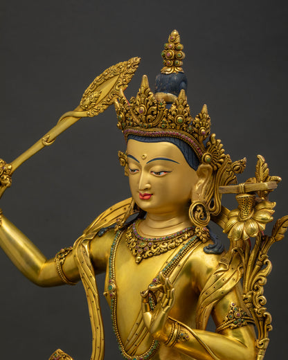 Side detail view of hand-carved copper jewelry on Manjushri statue