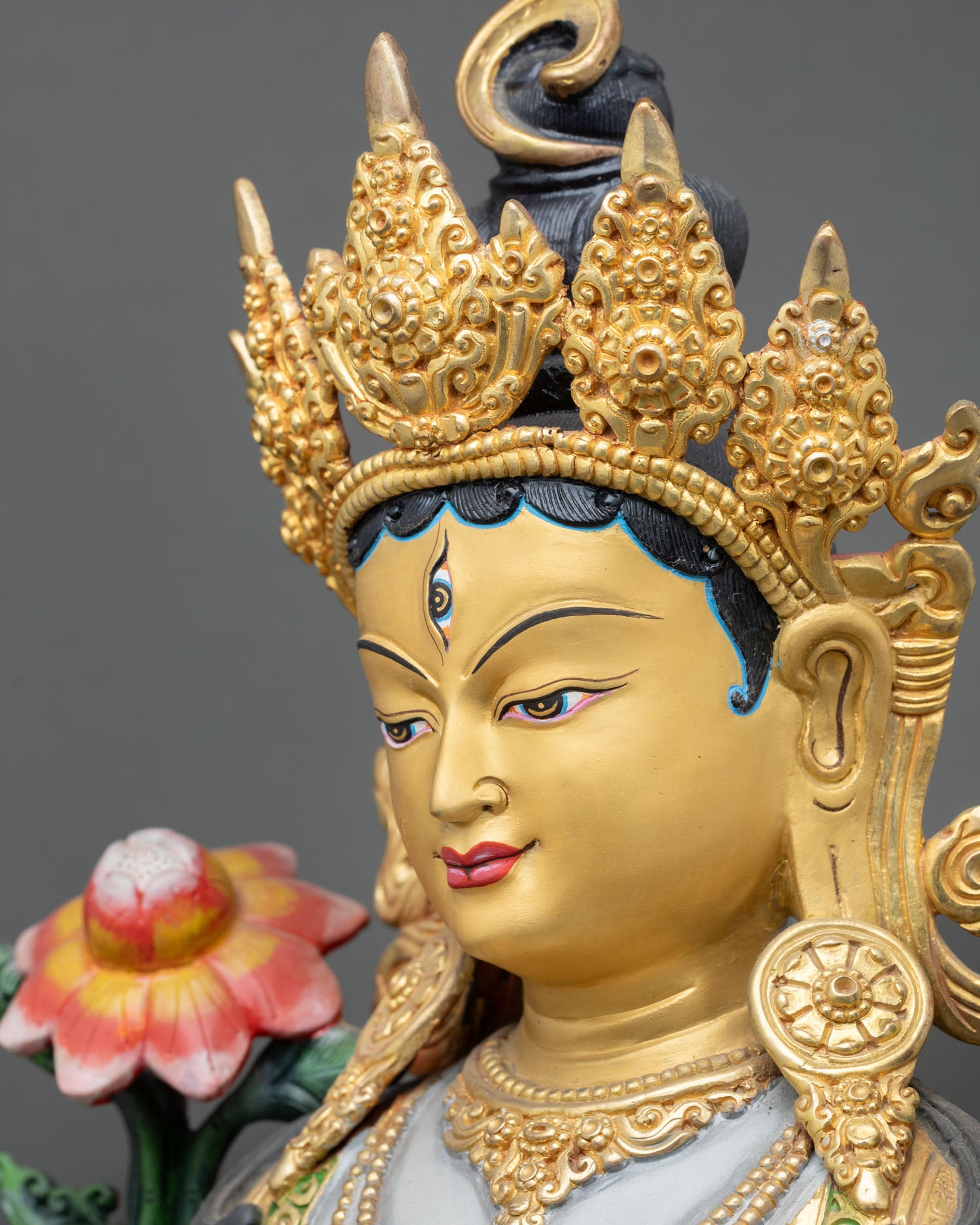 side face close-up of white tara buddhist statue with seven compassionate eyes