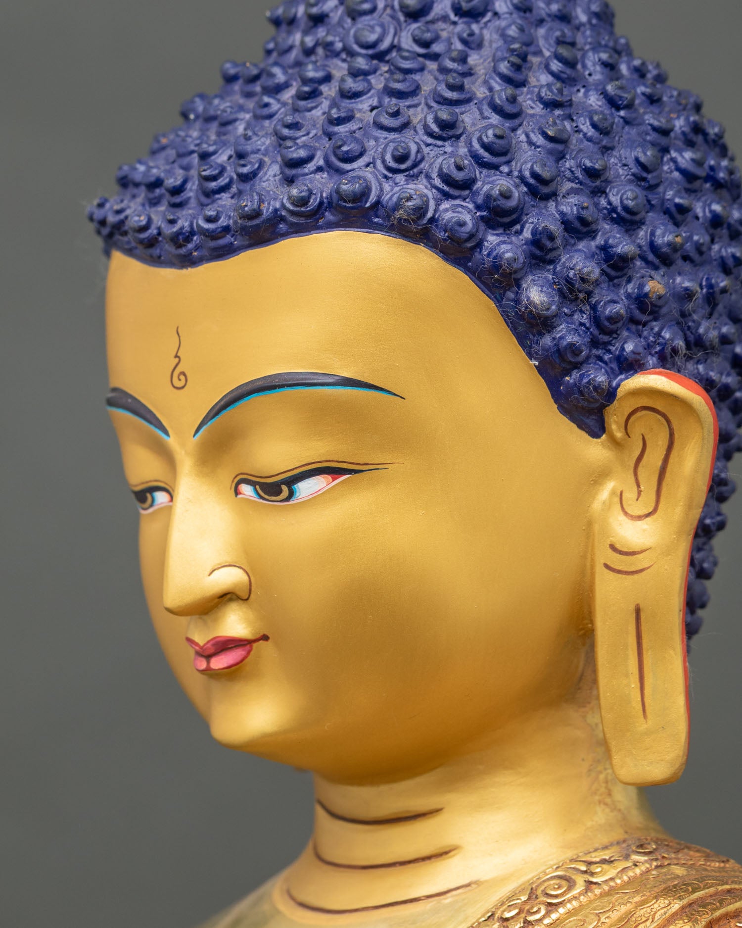 Side face close-up of Shakyamuni Buddha, detailed gold and copper features