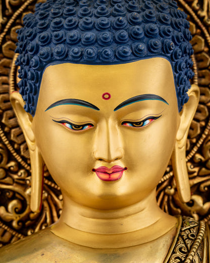 Side profile close‑up of Amitabha Buddha statue face with gentle expression and intricate halo carvings