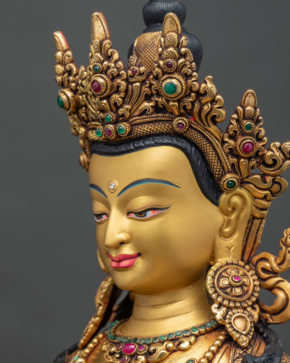 Side profile close up of Amitayus Buddha face with gold-painted features and five-jeweled diadem