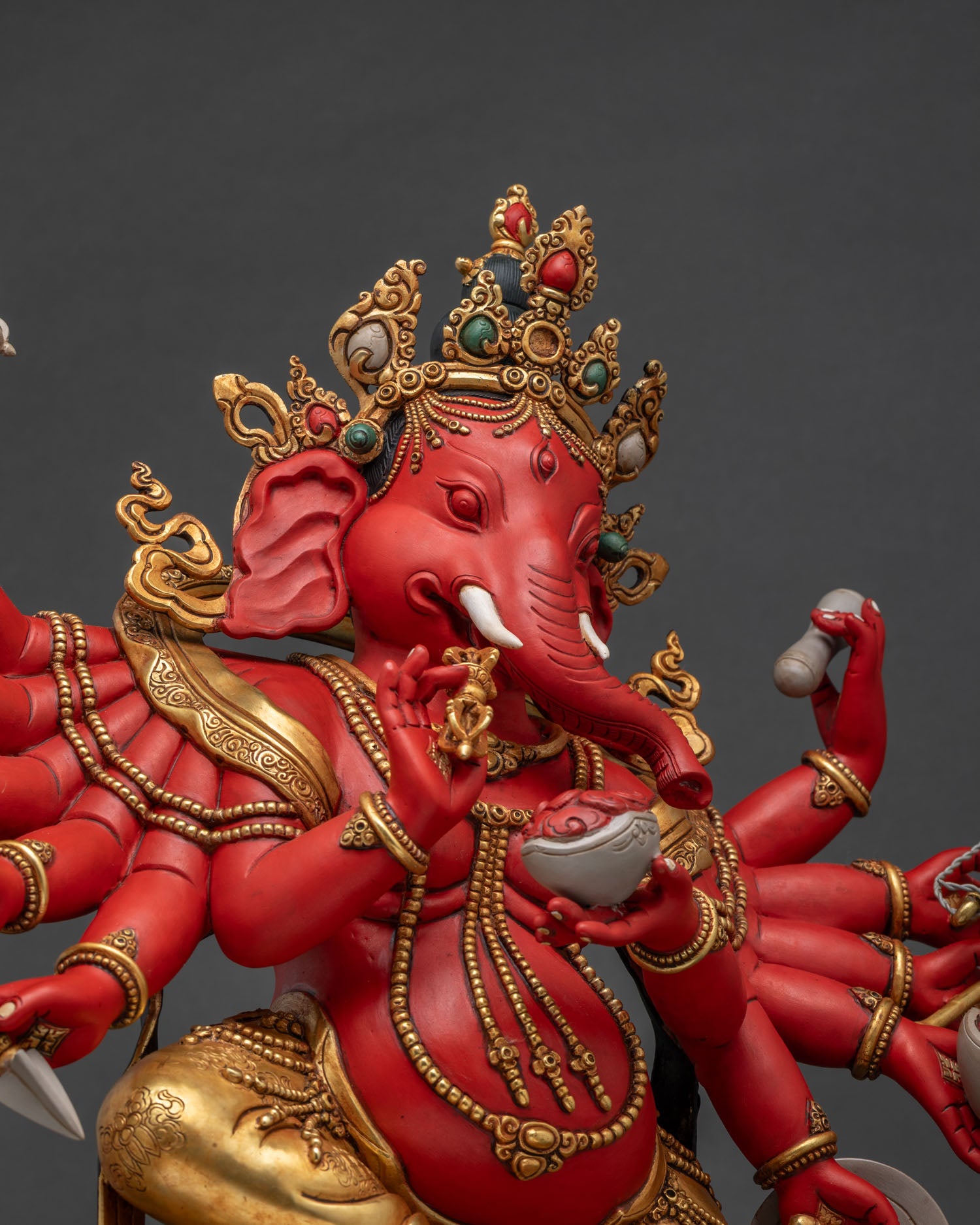 Side Profile Close-Up of Ganesh Idol's Face and Ornate Crown Detailing