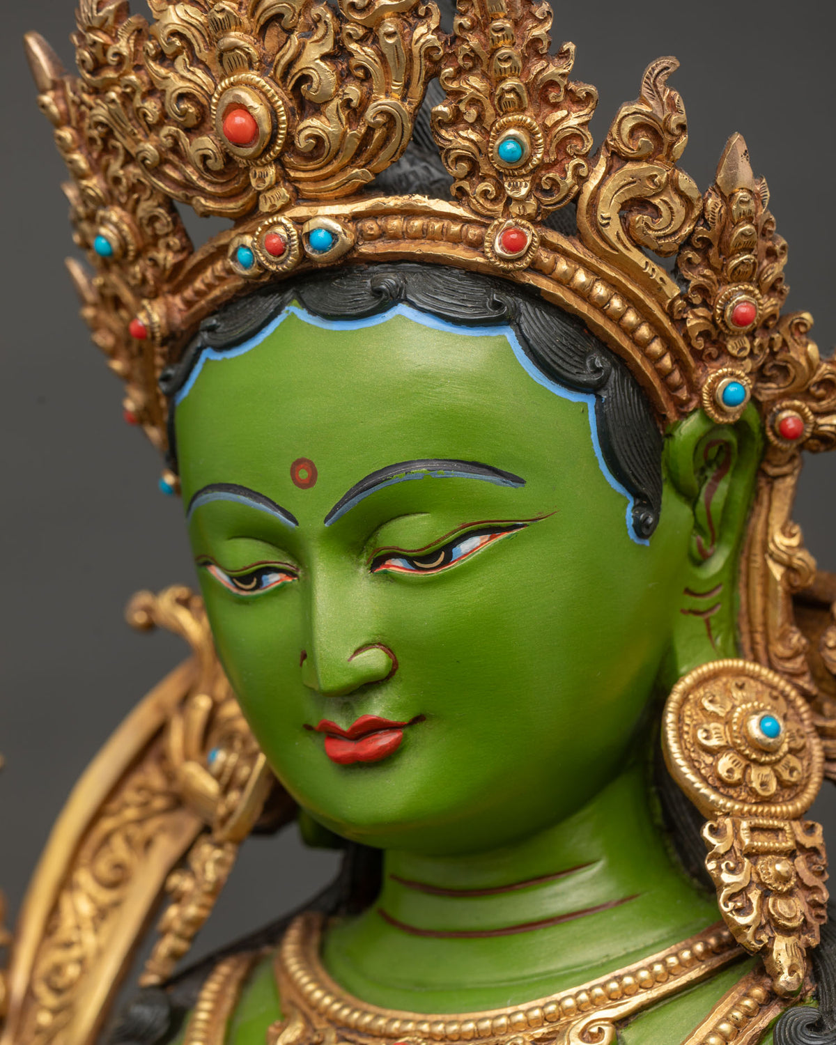 Side profile close-up of Green Tara face and jewel crown, handcrafted Nepali Buddhist statue