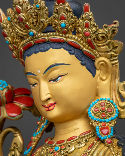 Side profile close-up of Green Tara statue face with hand-painted eyes and jeweled gold crown