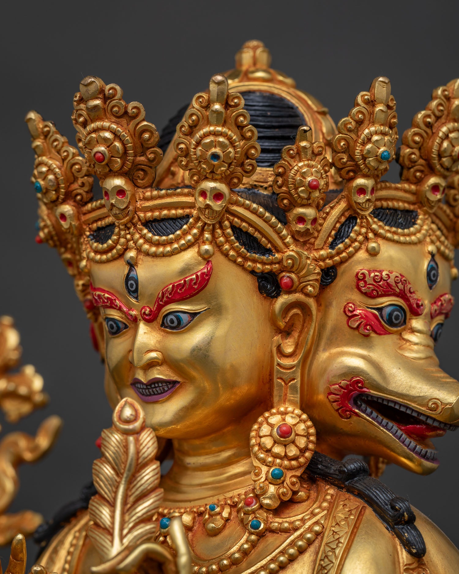 Side profile close-up of Marichi's face, sow head detail, gold fire-gilded Buddhist statue
