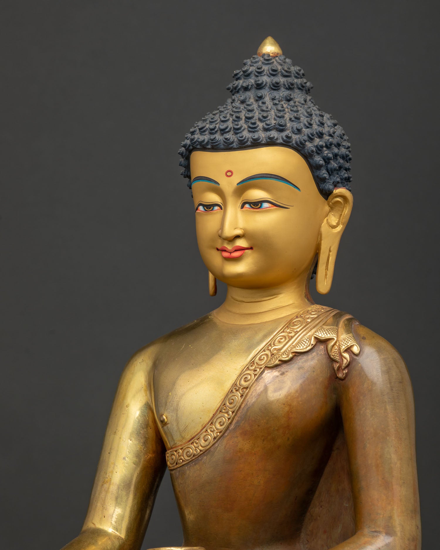 Side profile close-up of serene gold-painted Shakyamuni Buddha face