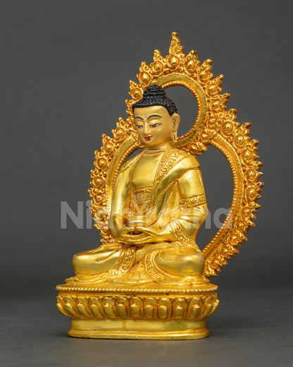 Side profile of gold Amitabha Buddha statue seated on lotus throne with ornate halo
