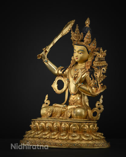 Side profile of gold fire-gilded Manjushri statue showing crown and seated lotus pedestal