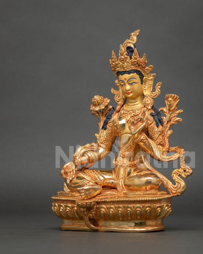 Side profile of Green Tara Buddhist statue showing carved lotus flower and gilded body