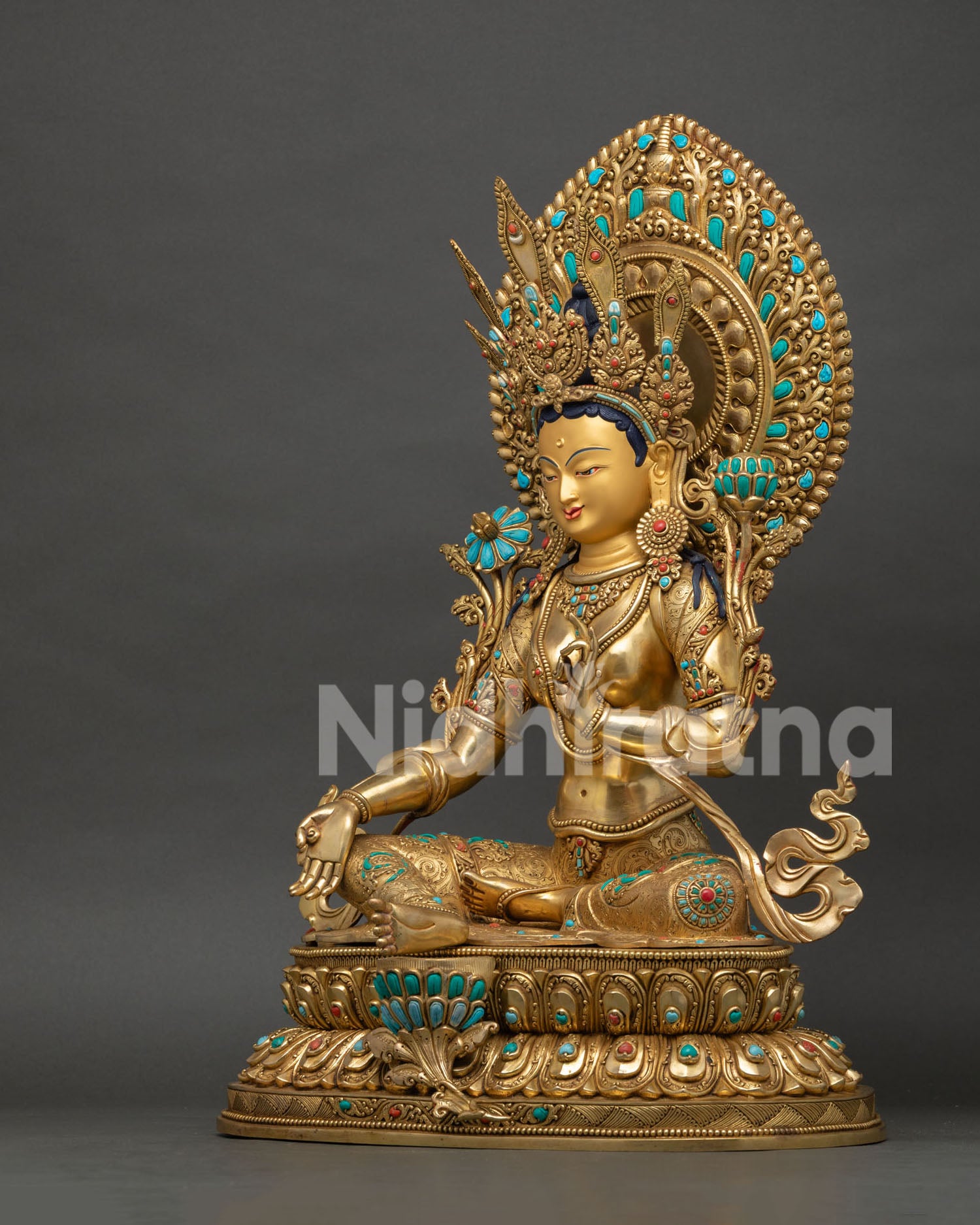 Side profile of Green Tara statue highlighting elaborate halo, lotus seat and gilded craftsmanship