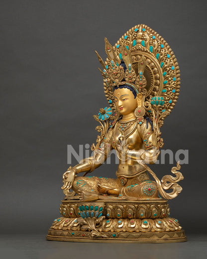 Side profile of Green Tara statue highlighting elaborate halo, lotus seat and gilded craftsmanship