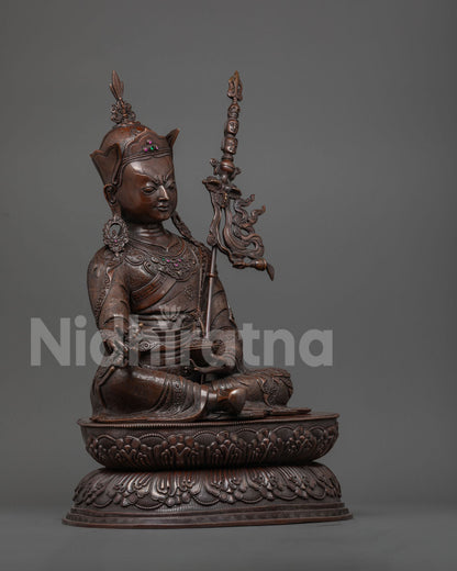 Side profile of oxidized copper Padmasambhava statue on lotus pedestal, handcrafted in Nepal