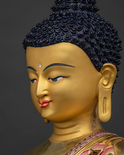 Side profile of Shakyamuni Buddha's gold-painted face, lost-wax cast statue