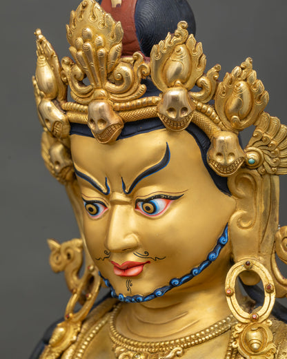 Side profile of Yellow Dzambhala statue face with painted eyebrows, mustache and five-jeweled crown