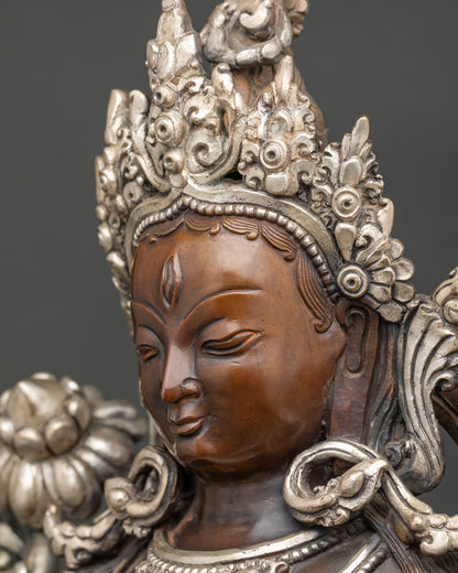 Side profile White Tara statue face with crown and Himalayan artisan metalwork