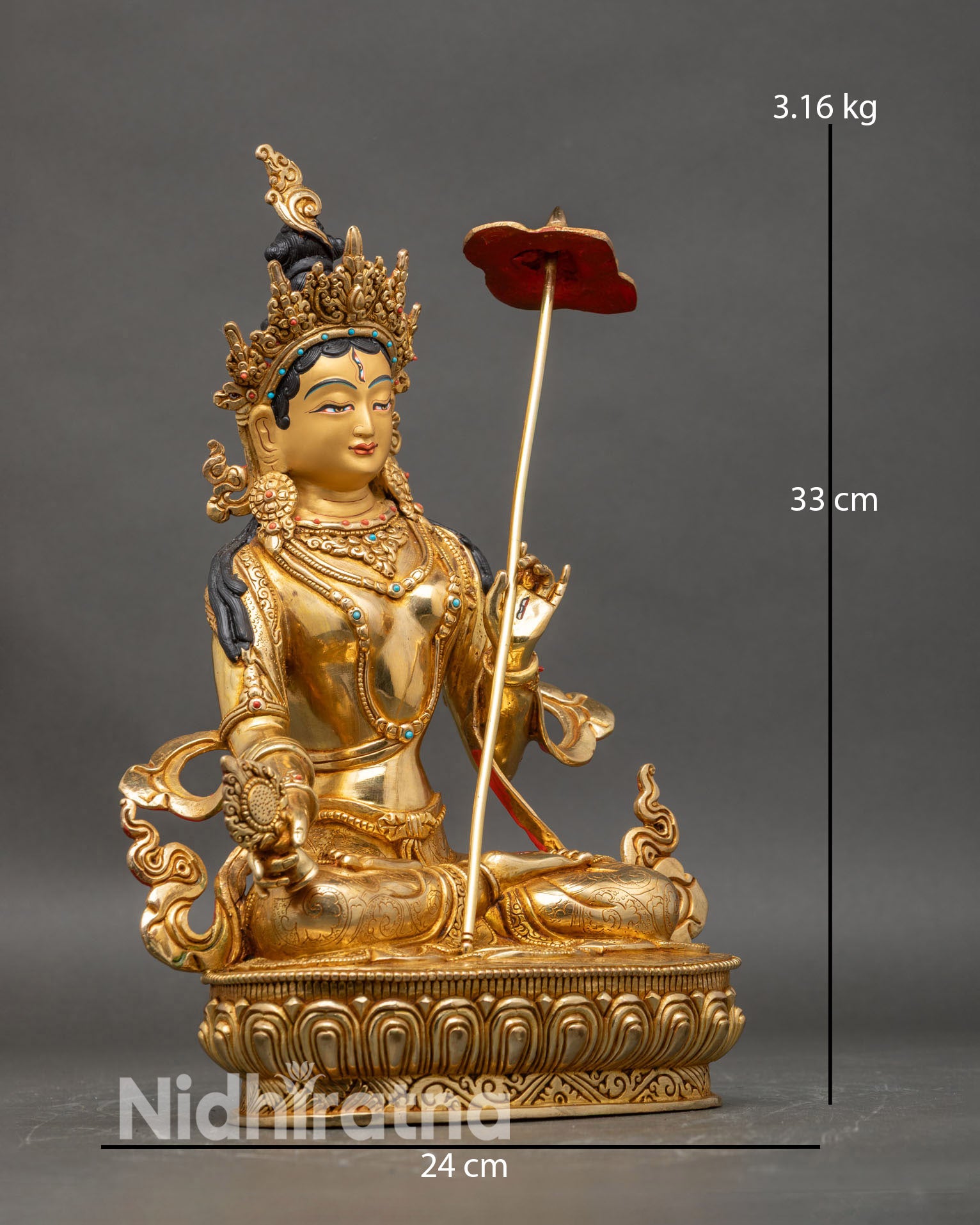 side view of Dukar statue holding white parasol Dharma wheel traditional Tibetan iconography