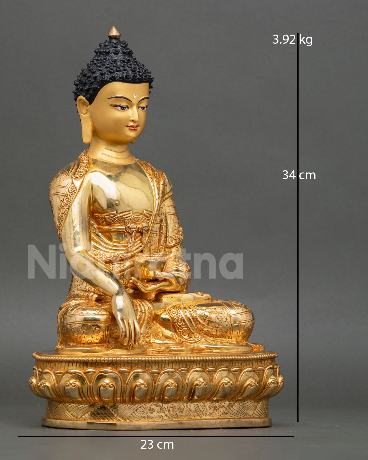 Side view of Buddha Shakyamuni statue holding begging bowl seated on lotus throne with finely carved monastic robes and sacred Nepalese artisan detail