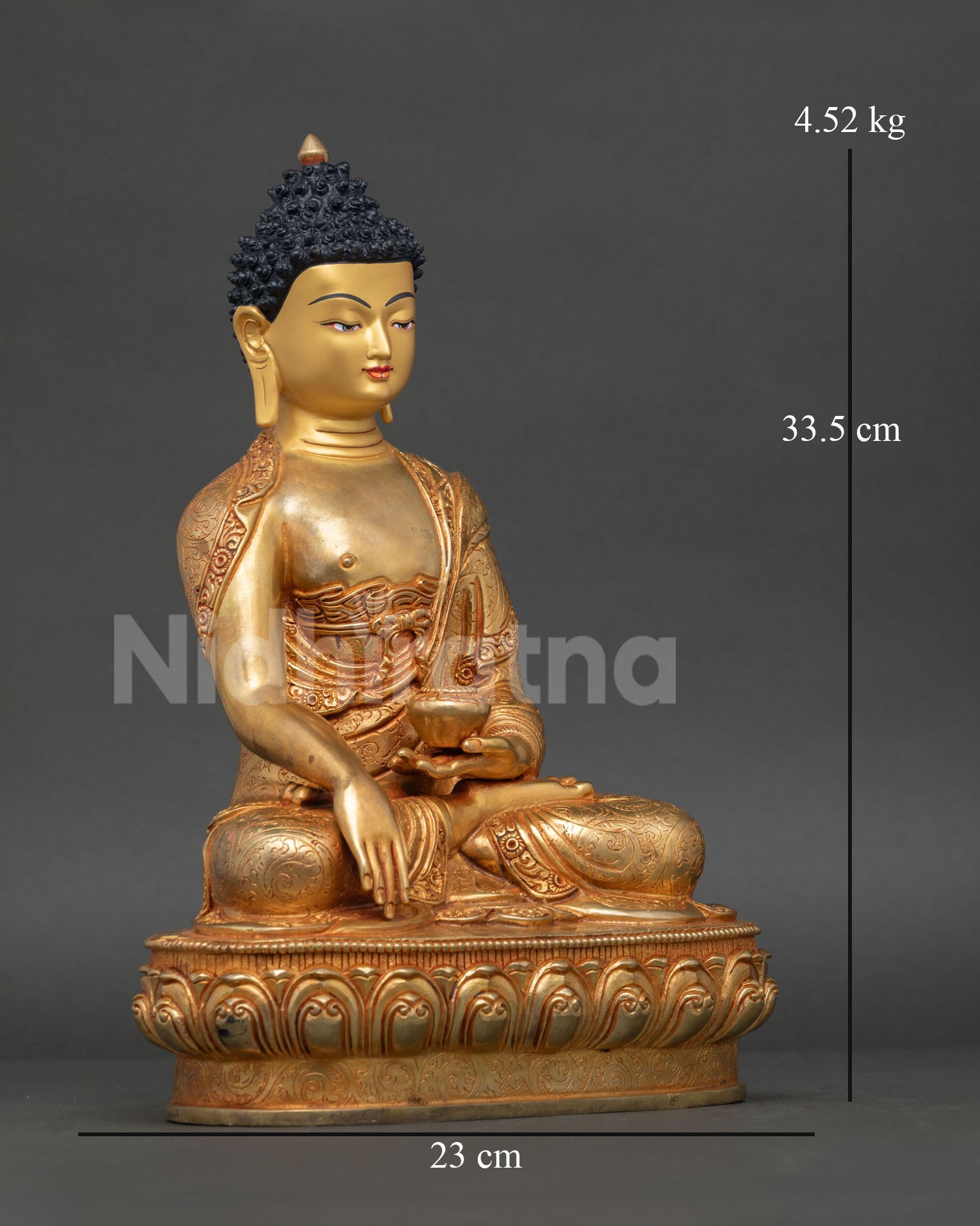 Side view of Buddha Shakyamuni statue, meditative posture, lotus pedestal, copper and gold gilded spiritual decor