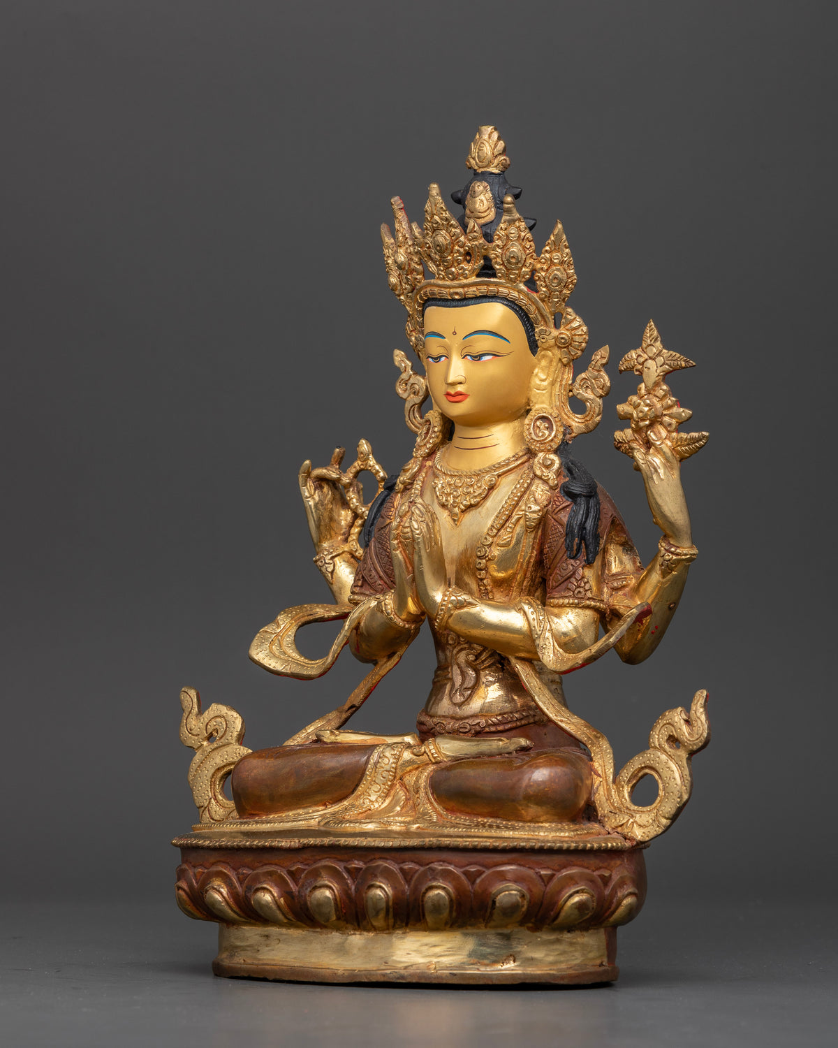 Side view of Chenrezig statue featuring half oxidized and gold fire gilded copper finish.