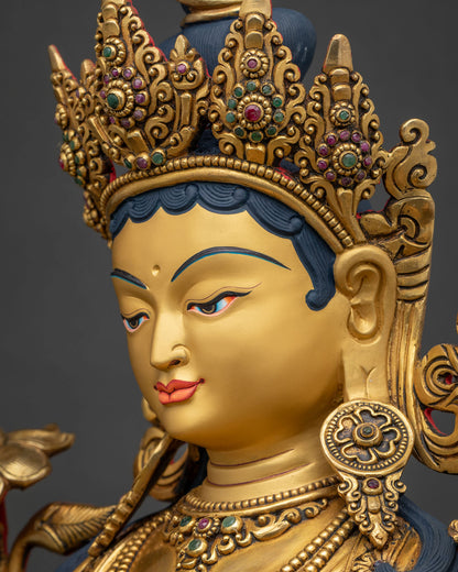Side view close-up of Green Tara statue's face and five-jeweled crown
