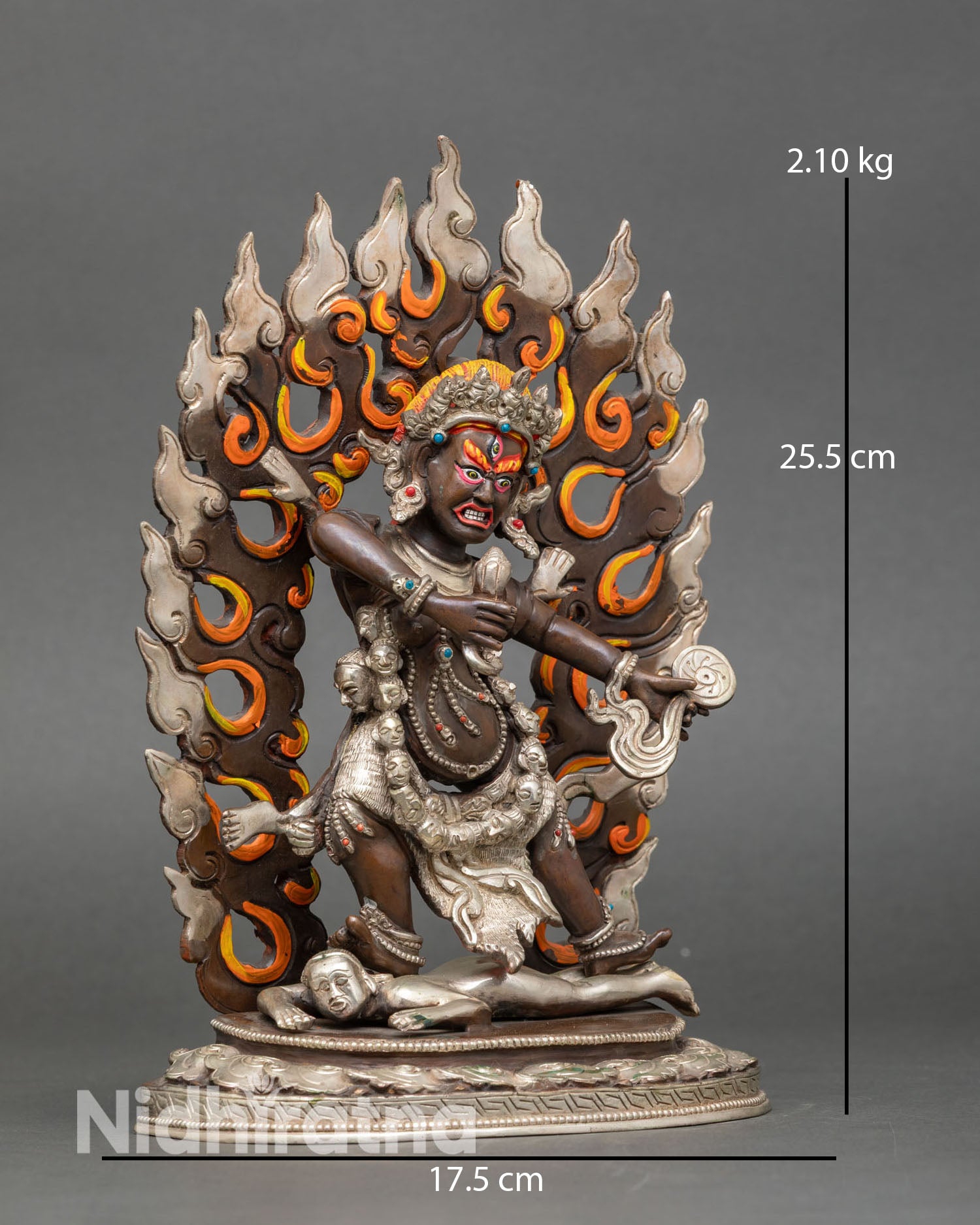 Side view of Drogdze Wangmo statue standing on lotus pedestal above subdued figure holding heart and mirror Vajrayana protector goddess sculpture