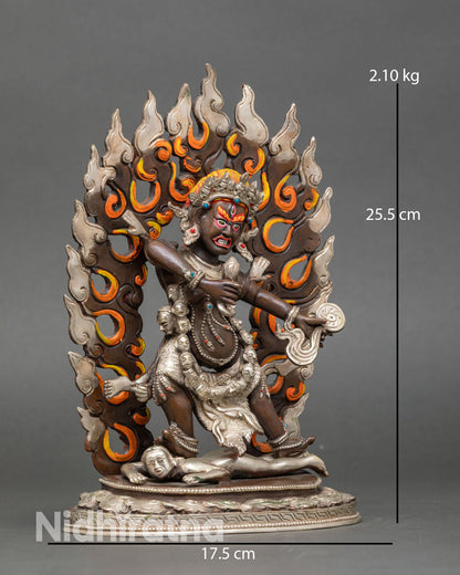 Side view of Drogdze Wangmo statue standing on lotus pedestal above subdued figure holding heart and mirror Vajrayana protector goddess sculpture