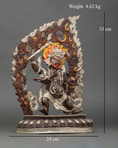 Side view of Four-Armed Vajrapani statue holding vajra and sacred implements dynamic posture encircled by flaming halo Buddhist protector deity Nepal