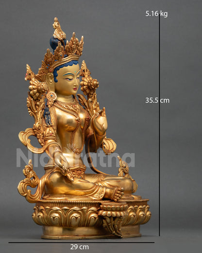 Side view of Green Tara seated posture of swift compassion copper statue with flowing ornaments 24K gold gilded finish 