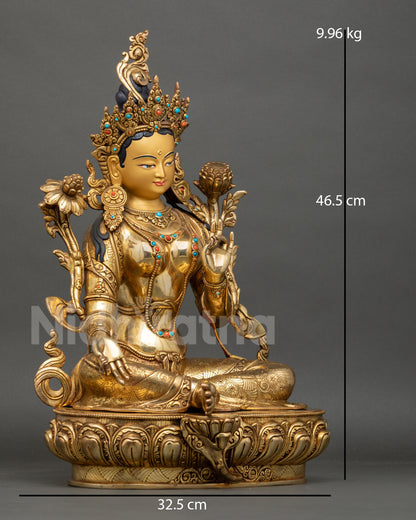 Side view of Green Tara statue holding utpala lotus with right leg extended symbolizing swift compassion and enlightened action