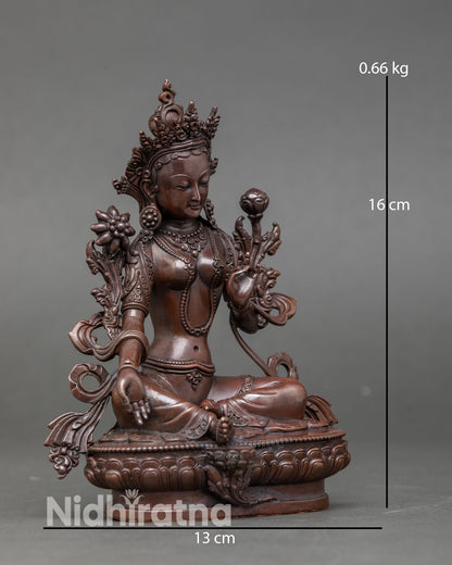 Side view of Green Tara statue Nepal handcrafted copper sculpture with antique oxidized finish right foot extended compassionate action gesture