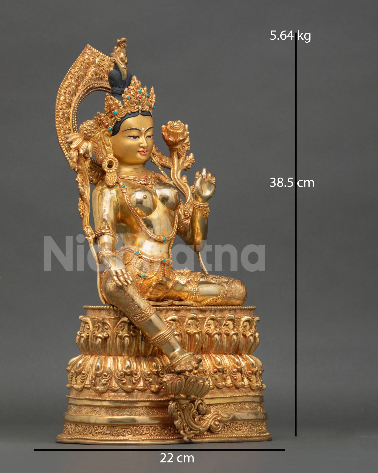 Side view of Green Tara statue seated in royal ease posture with flowing robes double lotus throne and sacred protection deity Nepal handcrafted sculpture