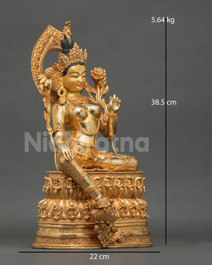 Side view of Green Tara statue seated in royal ease posture with flowing robes double lotus throne and sacred protection deity Nepal handcrafted sculpture