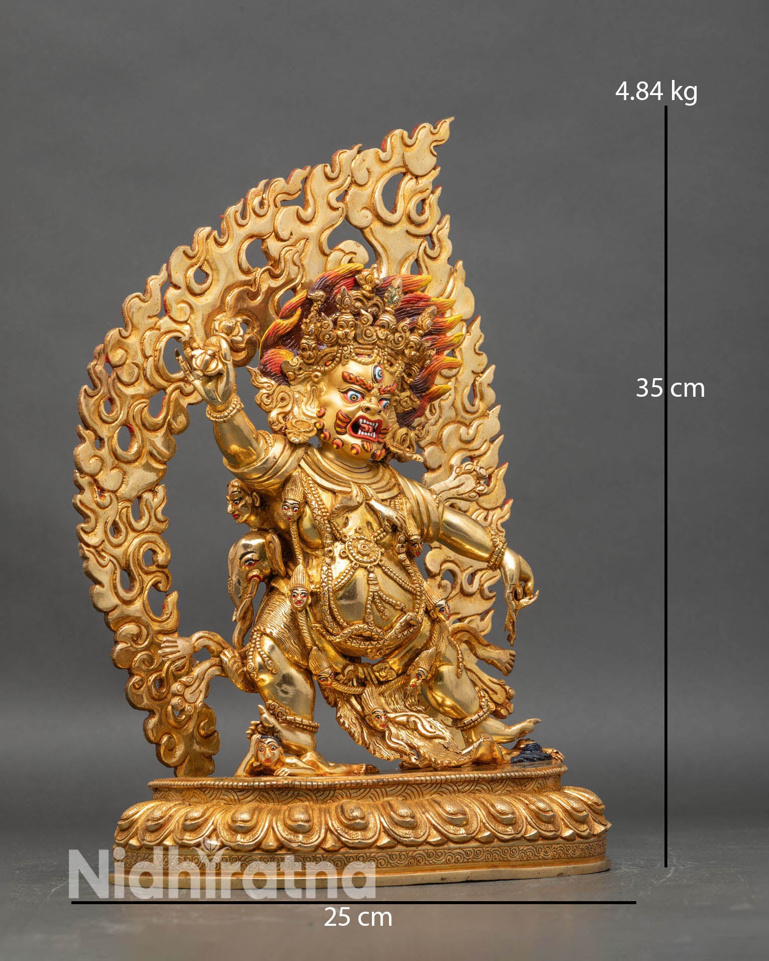 Side view of Guru Dragpo statue dancing posture blazing halo intricate robes sacred patterns Nepalese artisan