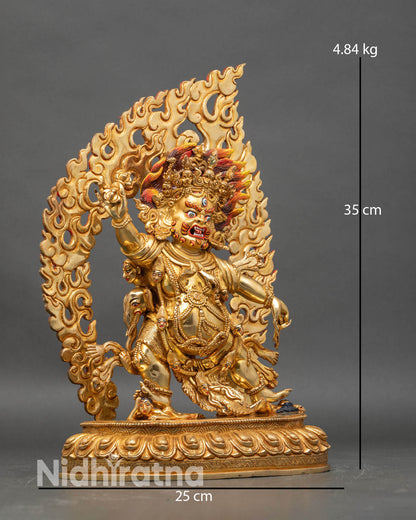 Side view of Guru Dragpo statue dancing posture blazing halo intricate robes sacred patterns Nepalese artisan