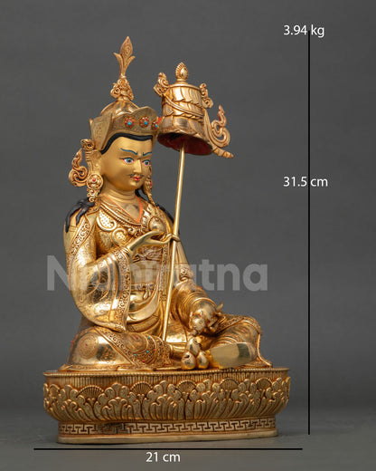 Side view of Guru Norlha prosperity deity statue with trident lotus hat and beautifully carved royal kasaya garments