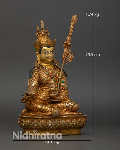 Side view Guru Rinpoche statue, khatvanga trident staff royal robes lotus seat Himalayan sculpture Nepal