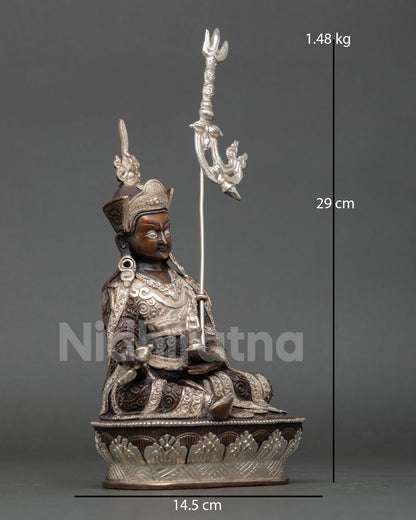 Side view Guru Rinpoche statue, trident staff, flowing robes, intricate Himalayan metal art copper sculpture meditation spiritual decor