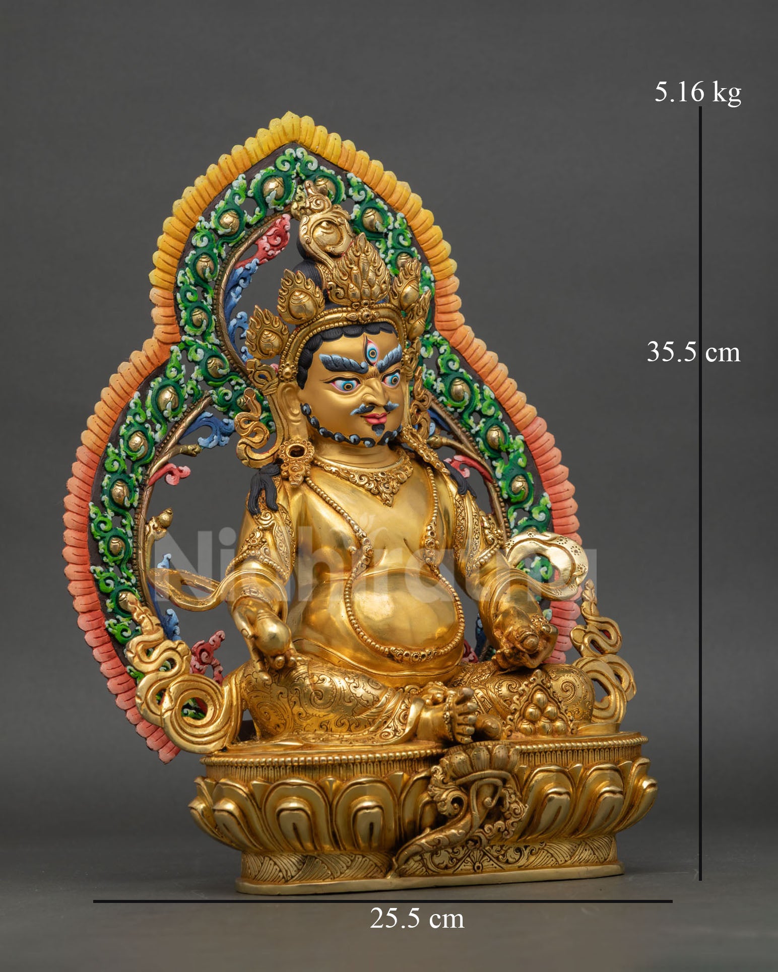 Side view of handcrafted Dzambhala statue from Nepal with detailed lotus base radiant halo design and gold gilded copper finish