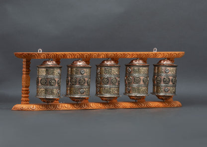 Side view of handcrafted five Mani Wheels Nepalese Buddhist sacred object