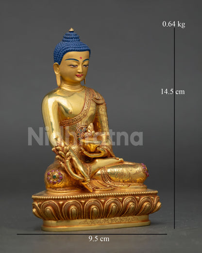 Side view of handcrafted Medicine Buddha statue in meditative posture with radiant gold gilded finish and detailed Himalayan Buddhist artistry