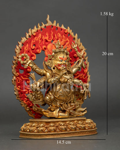 Side view of handcrafted Six Armed Mahakala sculpture with tiger skin robes multiple ritual implements and radiant halo of wisdom flames