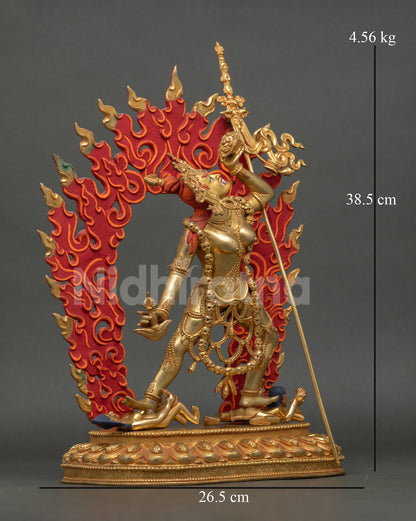 Side view of handcrafted Vajrayogini statue from Nepal with detailed ornaments ritual trident flaming aura and dynamic tantric dancing posture for meditation space.