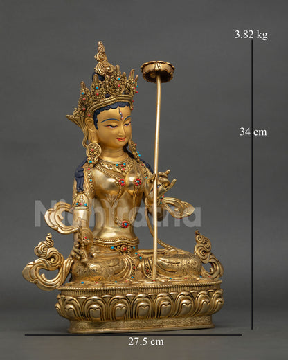 Side view of handcrafted White Parasol Bodhisattva statue from Nepal holding parasol and wisdom wheel, traditional lost wax copper artistry.