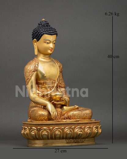Side view of Himalayan Buddha Shakyamuni sculpture with traditional monastic robes