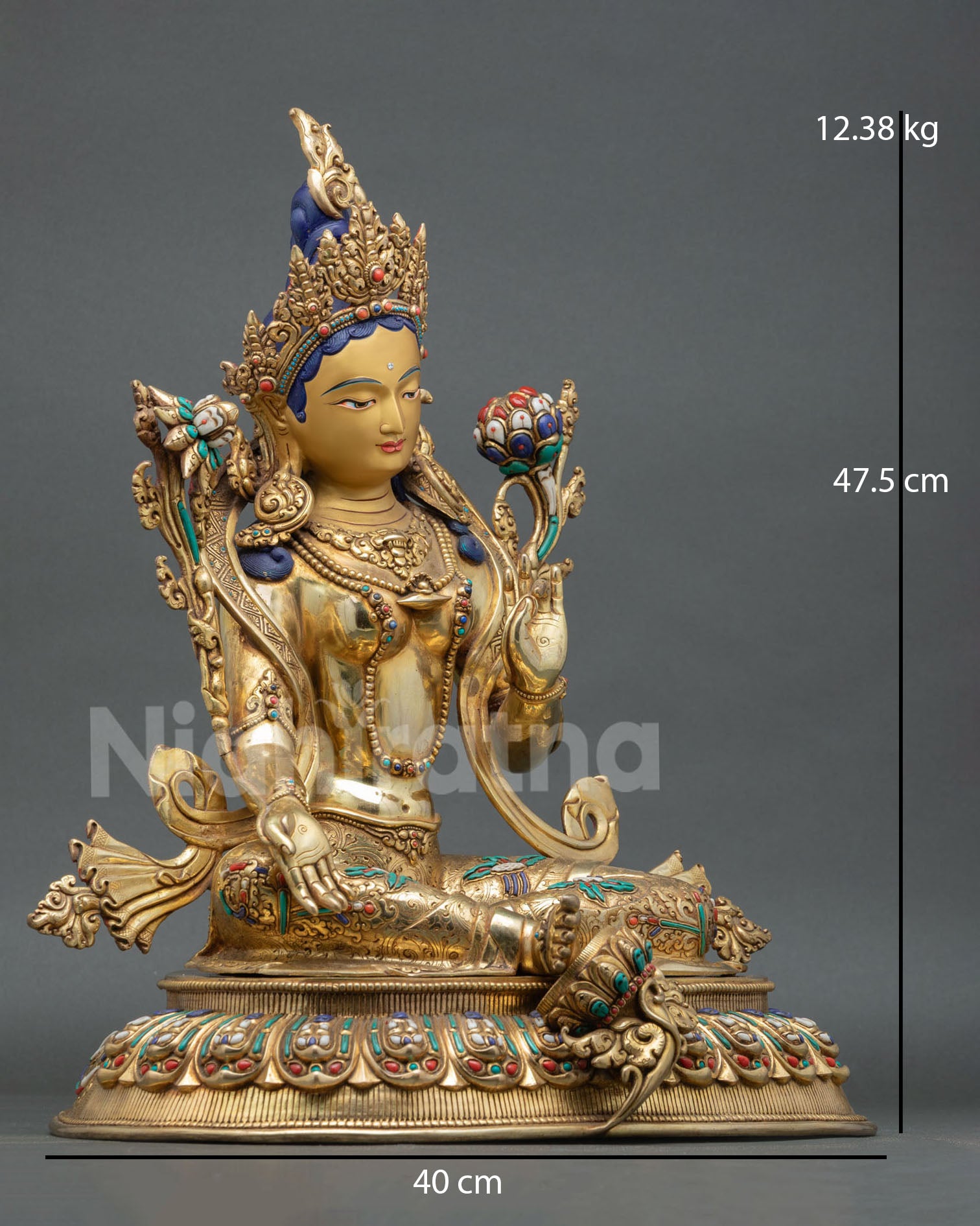 Side view of Himalayan Green Tara statue with extended right foot lotus motifs and lost wax casting metalwork