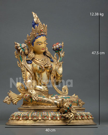 Side view of Himalayan Green Tara statue with extended right foot lotus motifs and lost wax casting metalwork