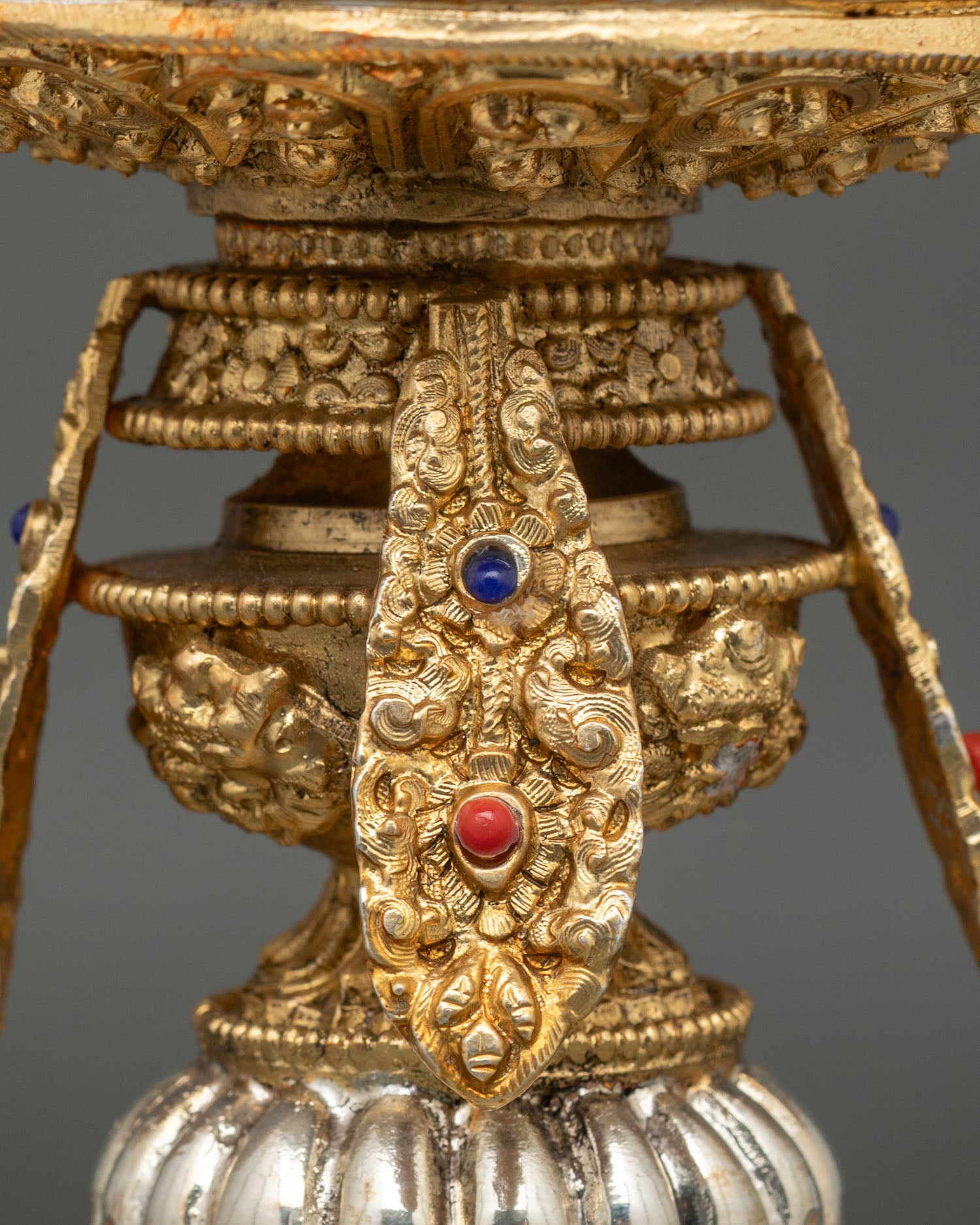 Side view of Himalayan ritual butter lamp displaying traditional copper structure with ornate detailing semi precious stone embellishments
