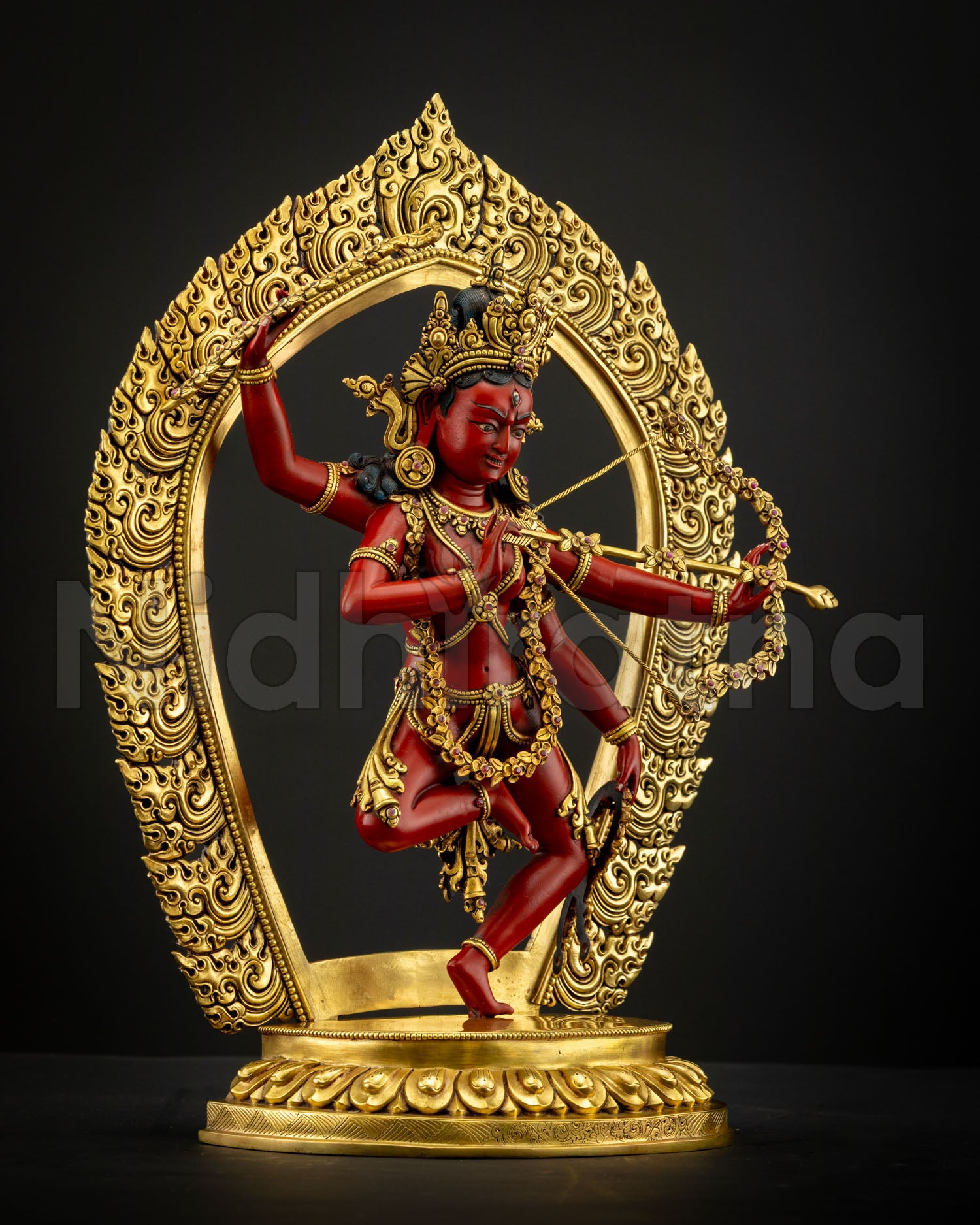 Side view of Kurukulla copper statue gold gilded finish flowing robes intricate ornaments and expressive tantric Buddhist feminine energy deity sculpture