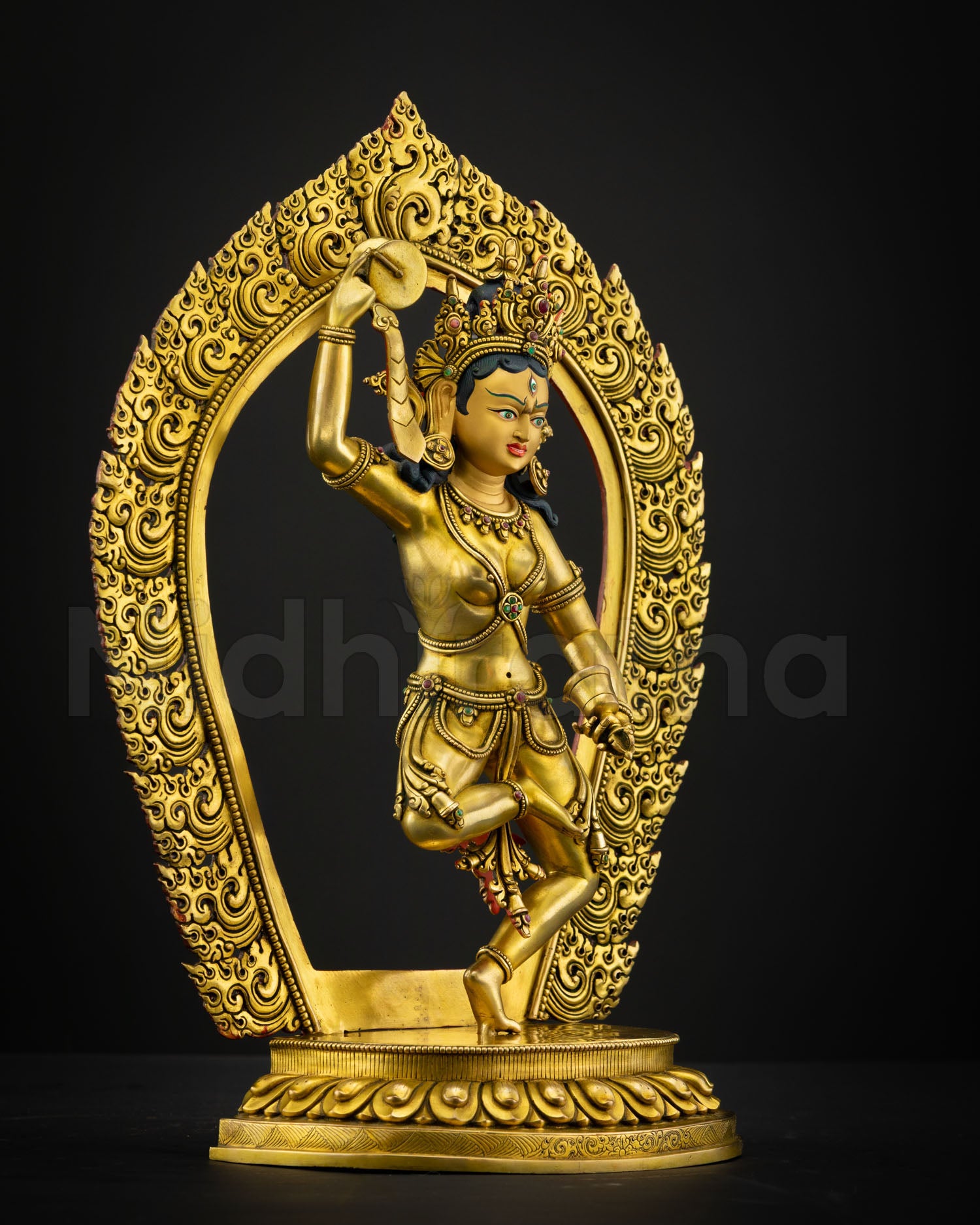 Side view Machig Labdron Himalayan sculpture holding damaru and ritual bell with detailed gold gilded craftsmanship by skilled Newari artisan from Patan Nepal
